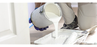 A man pouring white paint