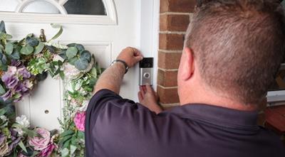 Blue Lamp Trust employee fitting a Ring Doorbell