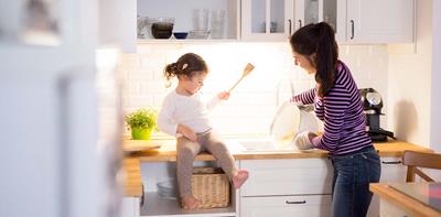 woman and young girl cooking together in the kitchen